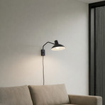 Lindby wall light Adrik, black, metal, with plug