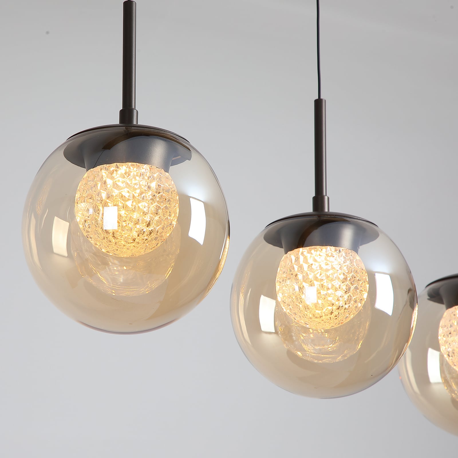 LED-Hängeleuchte Solis, 4-fl. lang, bronze, Glas, 2.700 K LED-Hängeleuchte Solis, 4-fl. lang, bronze, Glas, 2.700 K