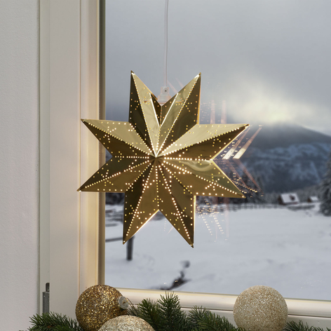Perforeret stjerne i poleret messing.