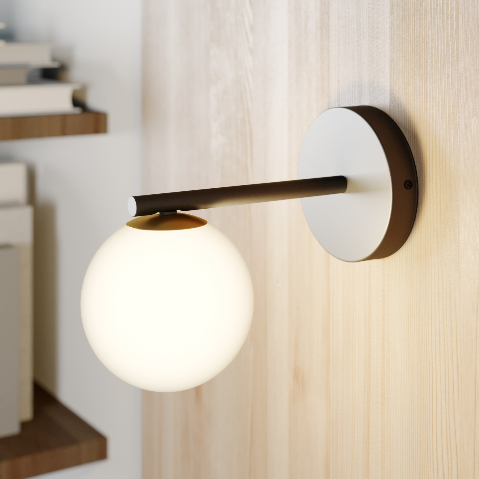 Gama wall light in black with a glass globe