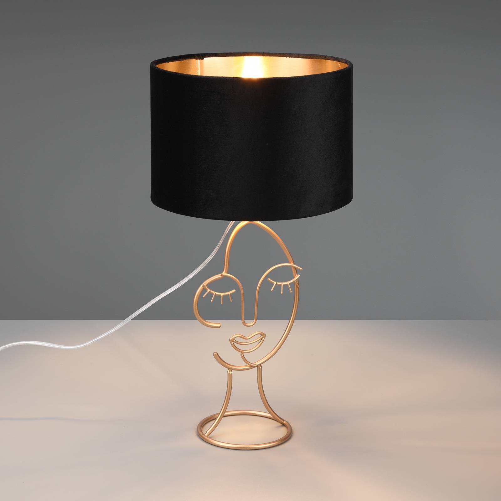 Reality Leuchten Mary table lamp with a face design, black/gold