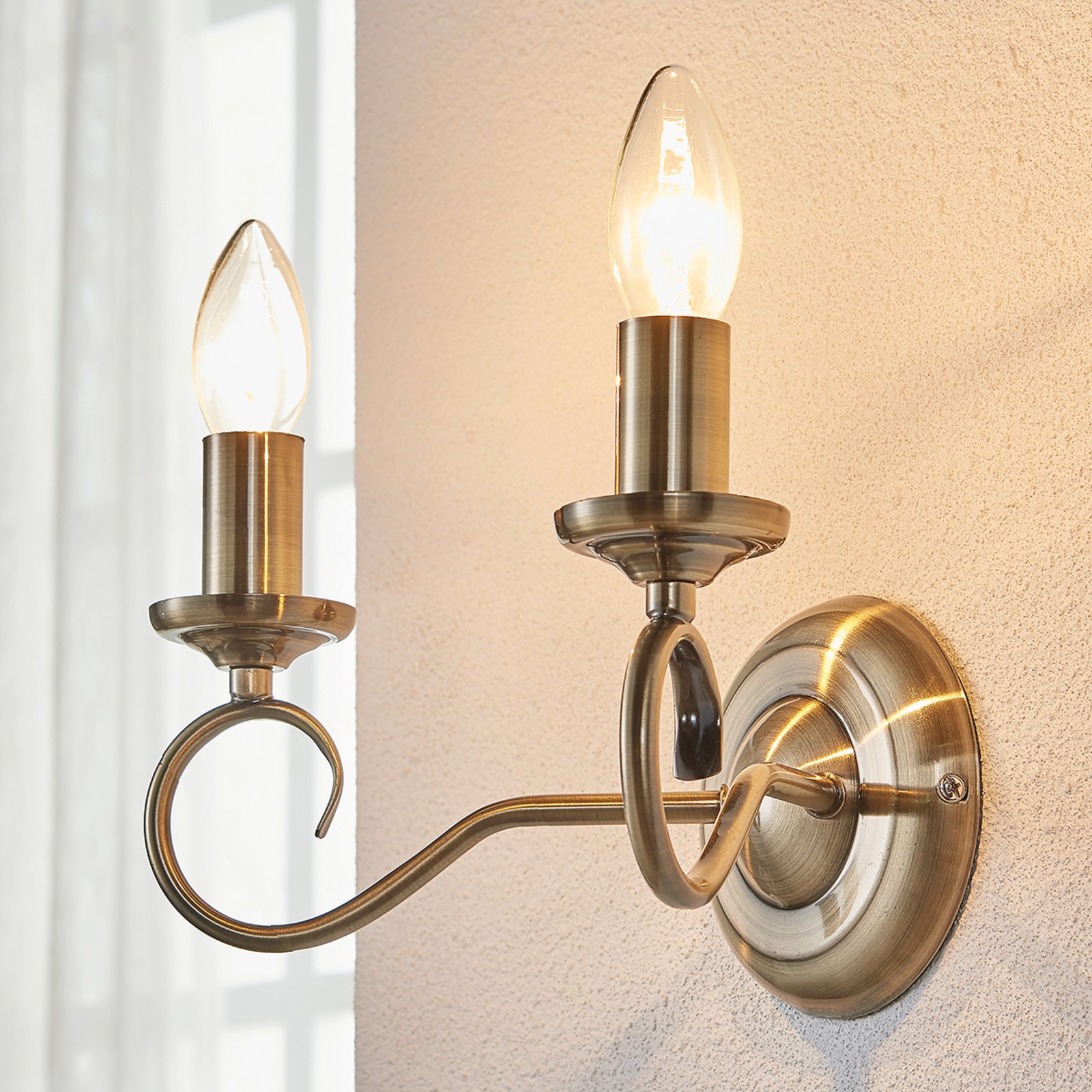 Elegant Marnia wall lamp in antique brass