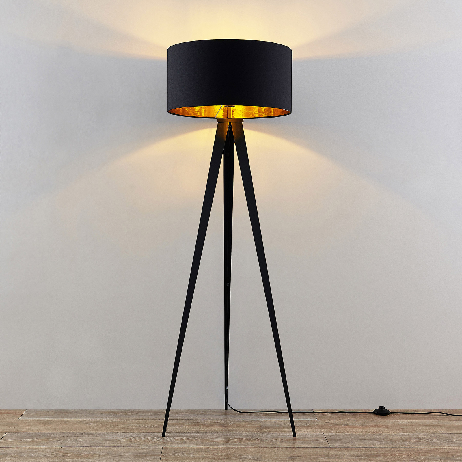 black and gold tripod lamp