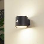 Lindby LED saules gaismas sienas lampa Amren, melna, ABS, sensors