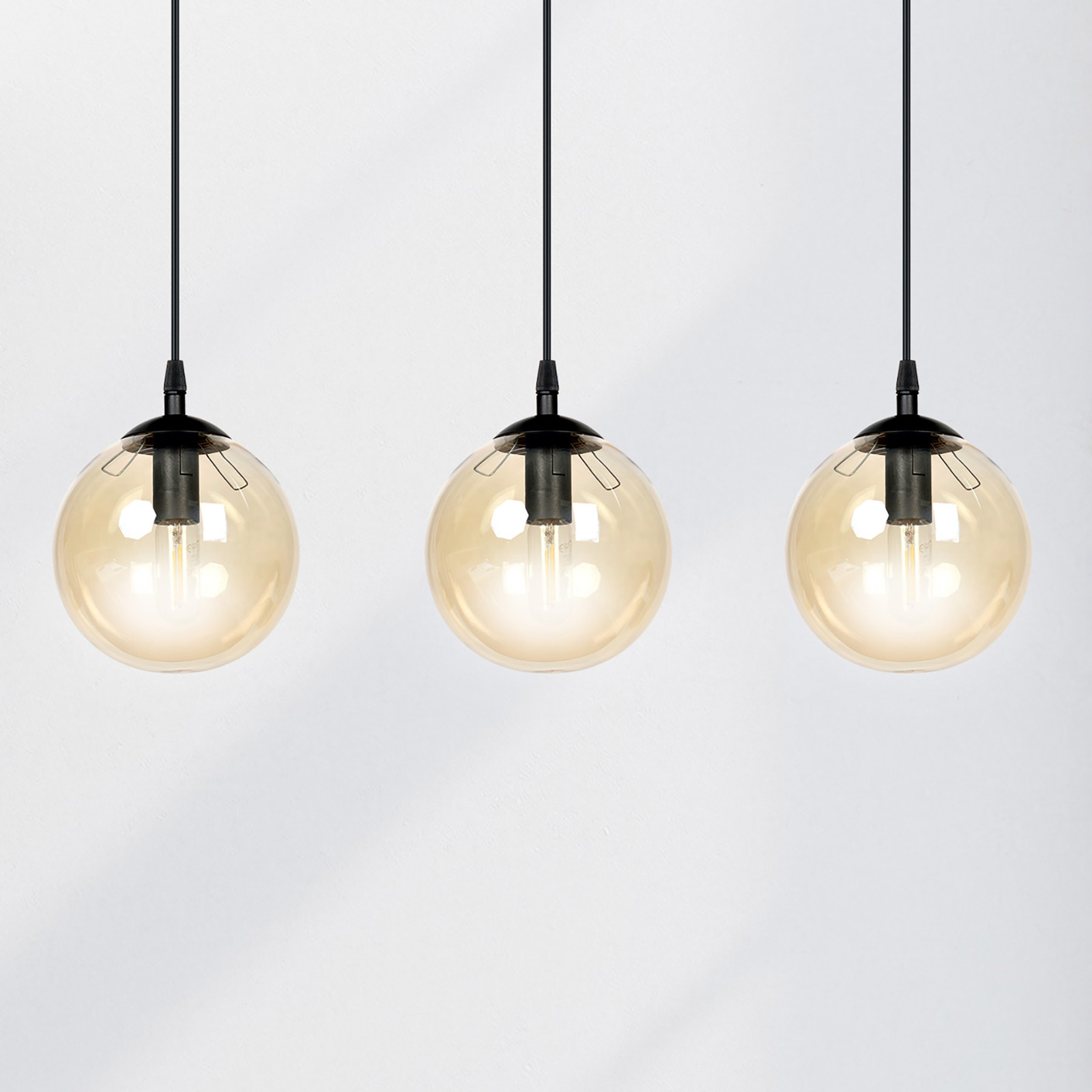 Glassy hanging light 3-bulb linear amber glass