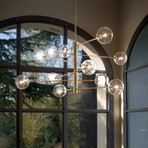 Suspension Equinoxe d'IDEAL LUX, laiton/ambre, à 12 lampes