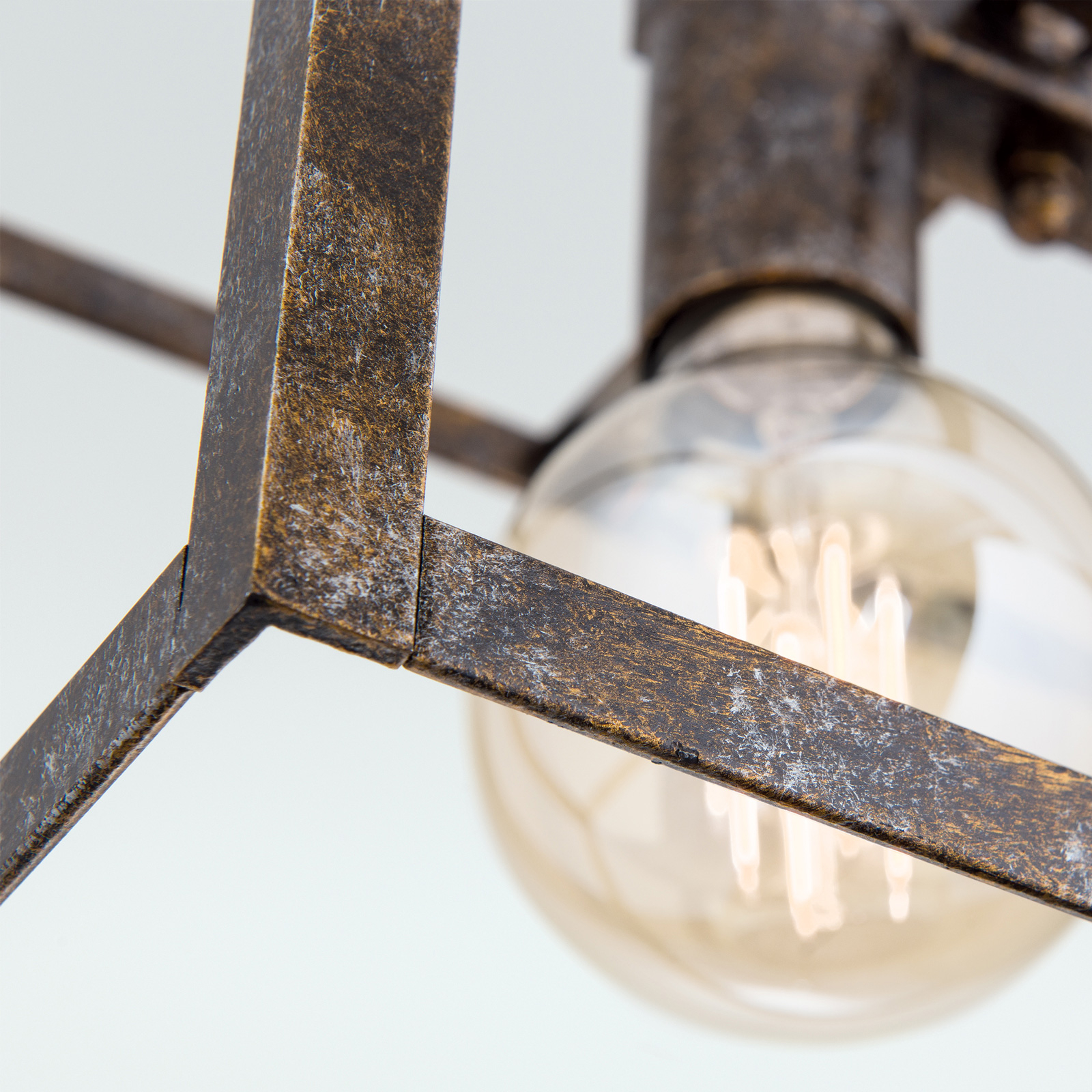 Cage hanging light in a rust look three-bulb